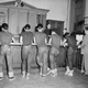 Five boys, all wearing blue jeans and the same dark shirt, stand in front of booking officer at the west 47th street police station in New York, July 31, 1954. The youths were among some 90 persons picked up by police in a drive on juvenile delinquents and "generally undesirable characters." All were round up in Time Square area. (AP Photo/Chris Daly)
